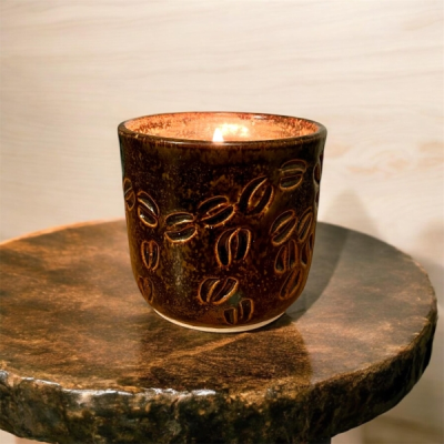 Coffee Bean Ceramic Pot - Indulge in the rich, comforting aroma of freshly ground coffee with our Coffee Bean candle, lovingly handmade in Denmead and poured into a unique ceramic pot handcrafted in Emsworth. Glazed in warm, earthy brown tones and decorated with a charming coffee bean motif, each pot is individually finished, making every piece truly one of a kind.

The fragrance captures the essence of a freshly brewed cup, offering a bold, inviting scent that fills your space with warmth and energy. Crafted from vegan-friendly soy wax and infused with paraben and phthalate-free fragrance oils, it’s perfect for enhancing your morning routine or creating a cosy, café-inspired atmosphere at home.

Each candle is presented in an organic cotton bag and comes with a candle care card to help you get the most from your purchase, along with instructions to repurpose the ceramic pot once the candle has burned down.

Locally made and full of character, this candle is a little piece of coffee comfort, created in Denmead — with a hand-crafted ceramic pot from Emsworth.