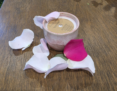 Rose Garden Ceramic Pot - Immerse yourself in the timeless beauty of a rose garden with our Rose Garden candle, lovingly handmade in Denmead and poured into a unique ceramic pot handcrafted in Emsworth. The pot, glazed in soft shades of pink, adds artisan charm and makes each candle truly one of a kind.

The fragrance blends the delicate scent of roses with fruity damson and warm amber spice, evoking the serenity of an evening in a summer garden. Crafted from vegan-friendly soy wax and infused with paraben and phthalate-free fragrance oils, it creates a rich, comforting atmosphere in any space.

Each candle is presented in an organic cotton bag and comes with a candle care card to help you get the most from your purchase, along with instructions to repurpose the ceramic pot once the candle has burned down.

Locally made and delicately romantic, this candle is a little piece of floral elegance, created in Denmead — with a hand-crafted ceramic pot from Emsworth.
